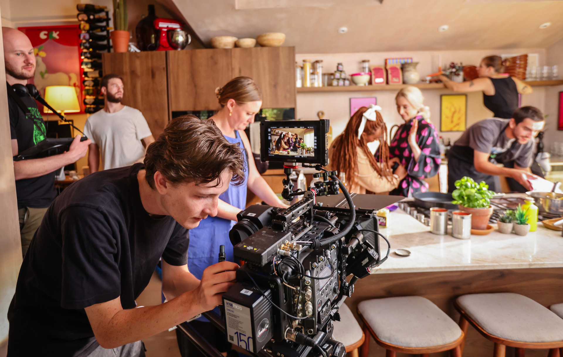 Camera operator and crew filming the Very Lazy kitchen set