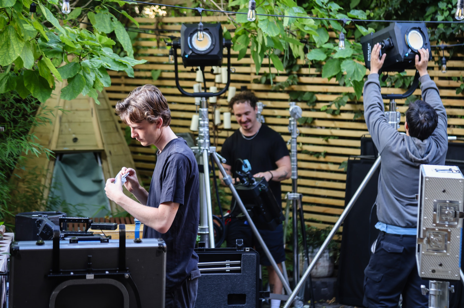 Crew setting up lighting and grip on the Very Lazy outdoor set
