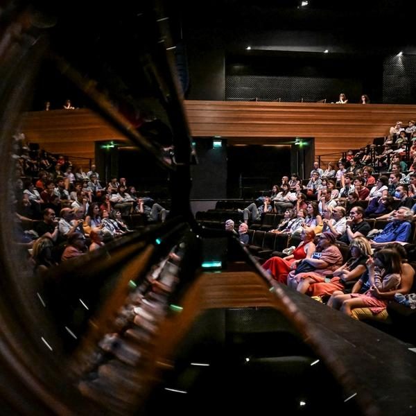Cinema audience reflected in a grand piano at Festival La Rochelle Cinéma